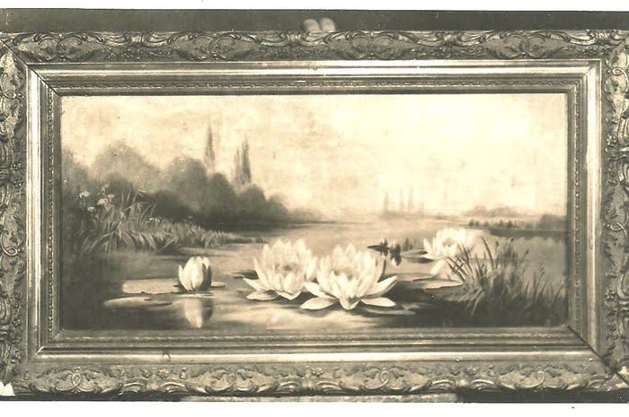 A black and white photo of a framed painting showing a landscape with lotus flowers.
